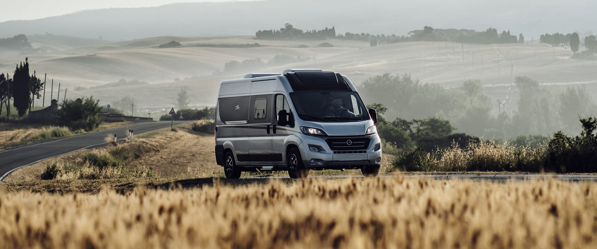 A motorhome with open countryside in the background